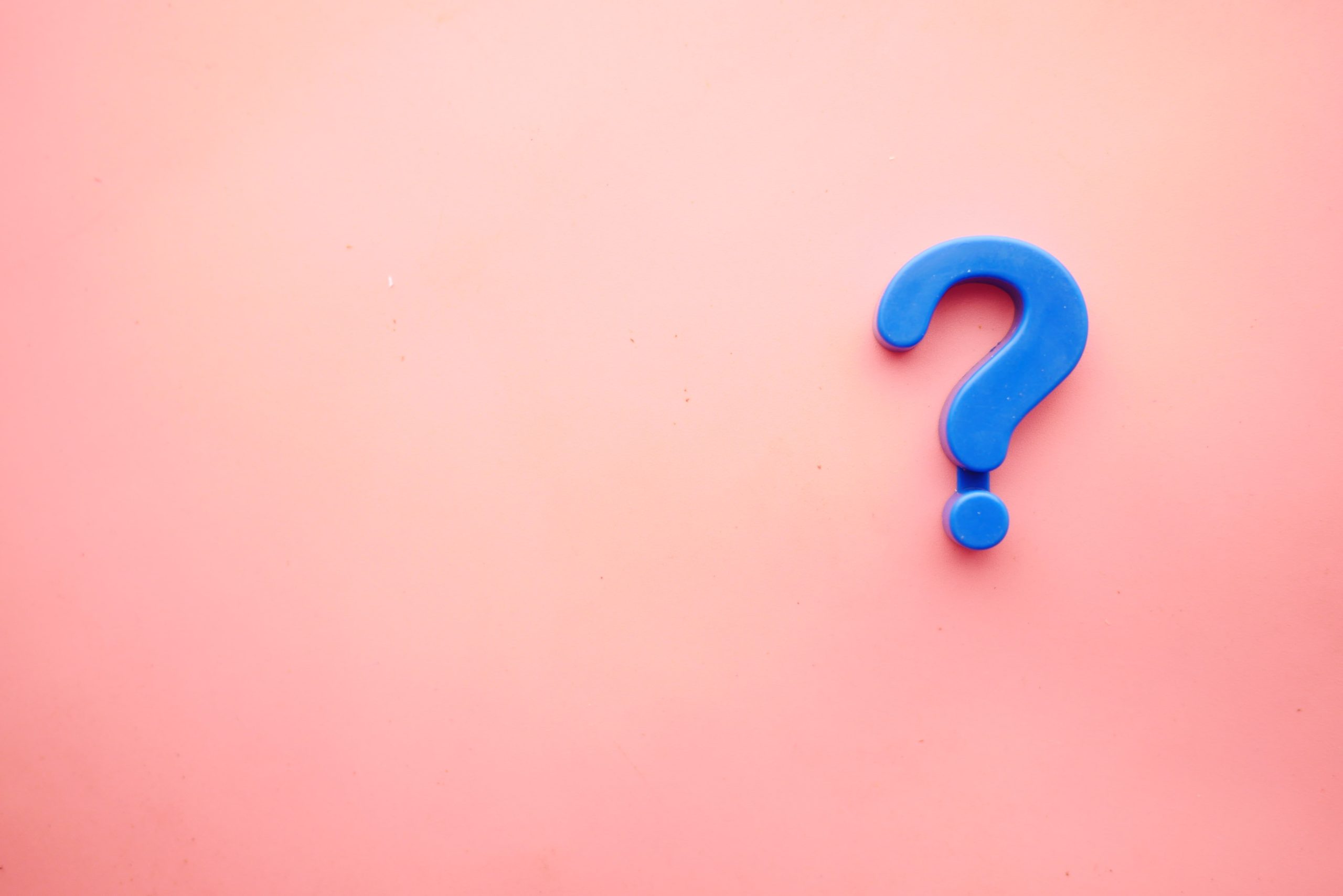 Pink background with blue question mark