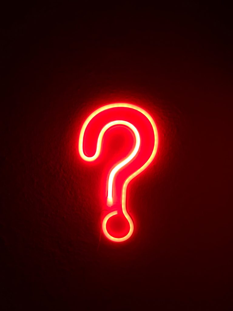 Dark background with neon red questionmark